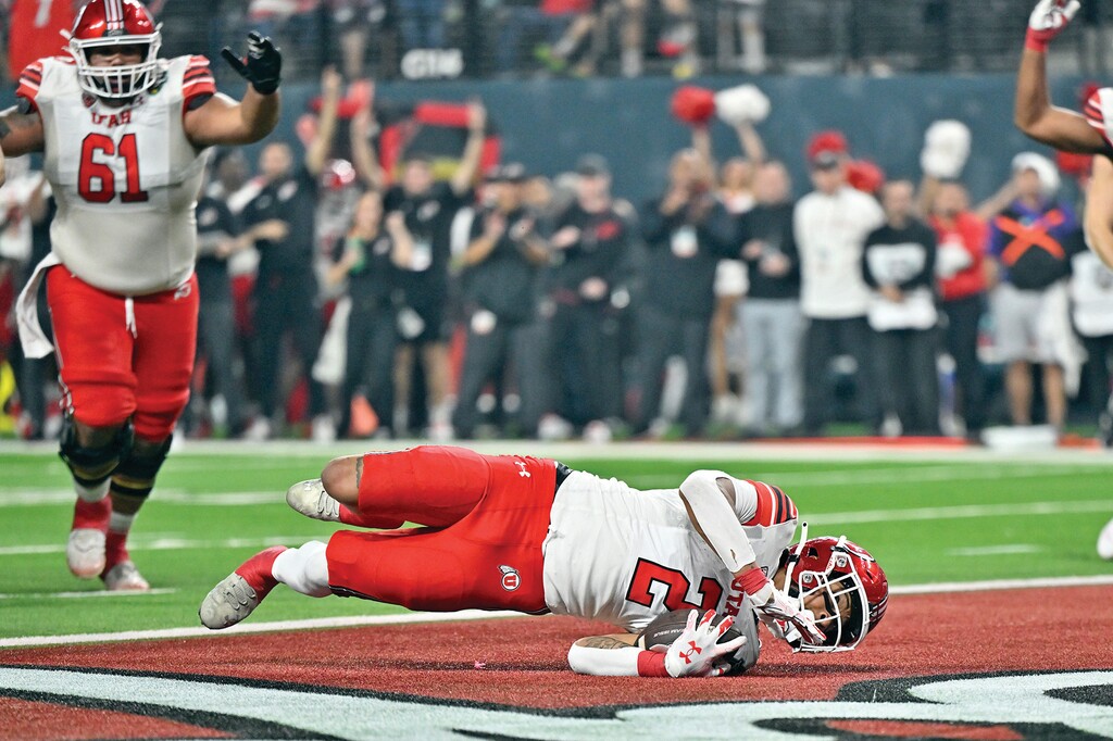 Utah running back Micah Bernard (2) dives into end zone for a touchdown against Northwestern during the second half of the Las Vegas Bowl NCAA college football game, Saturday, Dec. 23, 2023, in Las Vegas. (AP Photo/David Becker)
