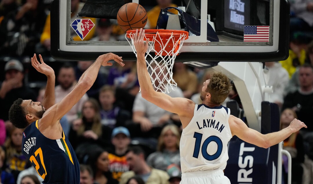 (Francisco Kjolseth | The Salt Lake Tribune) Utah Jazz center Rudy Gobert (27) tries to block Minnesota Timberwolves forward Jake Layman (10) on his way to the basket in NBA action between the Utah Jazz and the Minnesota Timberwolves at Vivint Smart Home Arena in Salt Lake City, Thursday, Dec. 23, 2021.