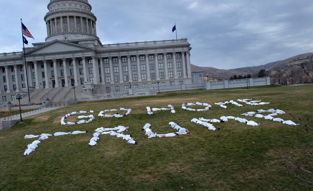 (Scott Sommerdorf   |  The Salt Lake Tribune)   Protesters dressed in white jumpsuits spelled out "GO HOME TRUMP" on the south lawn of the Utah State Capitol, Sunday, December 3, 2017, during a protest organized by artist Cat Palmer ahead of Trump's visit Monday. 