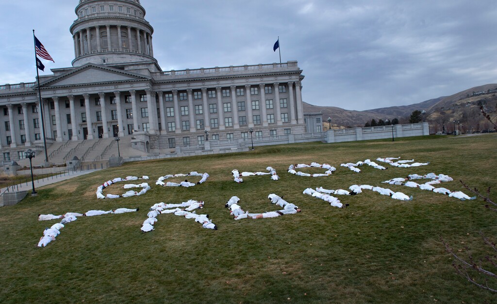 (Scott Sommerdorf | The Salt Lake Tribune)
Protesters dressed in white jumpsuits spelled out "GO HOME TRUMP" on the south lawn of the Utah State Capitol, Sunday, December 3, 2017, during a protest organized by artist Cat Palmer ahead of Trump's visit Monday.