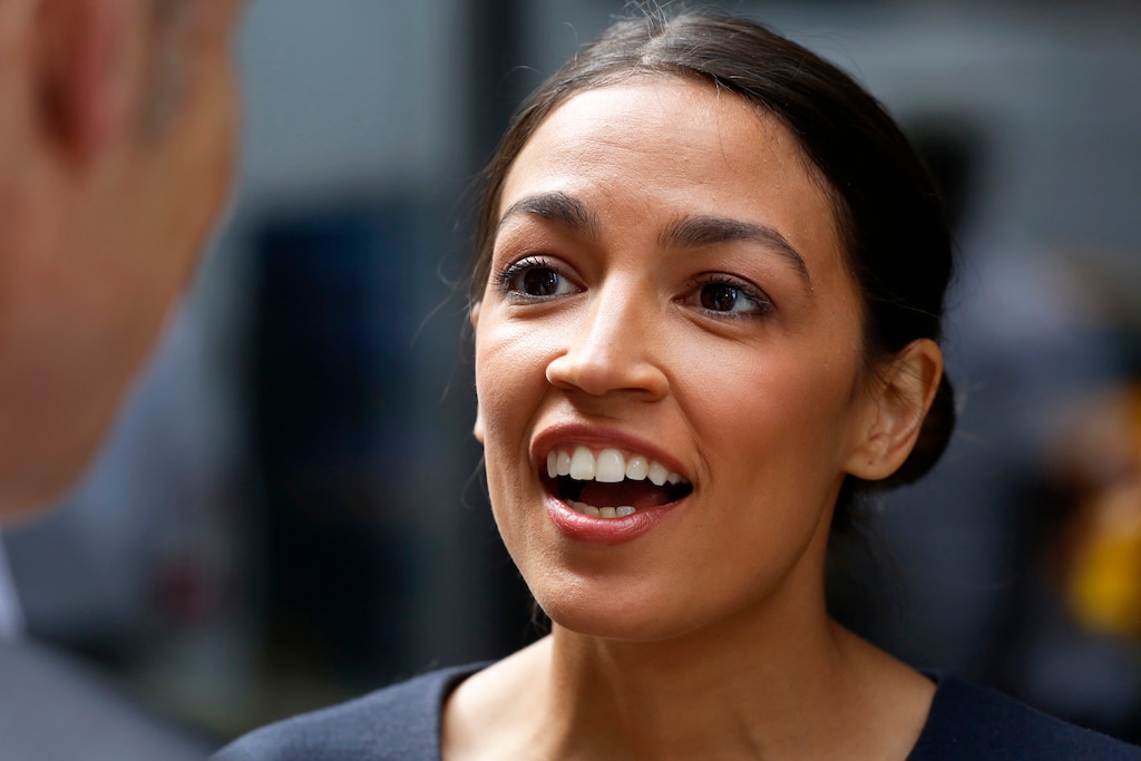 (Mark Lennihan | Associated Press file photo) In this June 27, 2018, photo, Democrat Alexandria Ocasio-Cortez  speaks to the media in New York, the day after her congressional primary upset over 10-term incumbent Joe Crowley. Ocasio-Cortez is now criticizing him for not getting his name off the ballot in the general election. Despite his loss in New York’s Democratic primary, Crowley’s name will still be on the ballot as the candidate of the lesser-known Working Families Party in November.