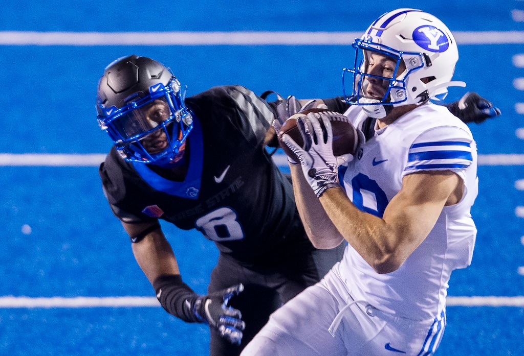 (Darin Oswald | Idaho Statesman via AP) BYU wide receiver Gunner Romney secures a pass while being defended by Boise State cornerback Markel Reed (8) Friday, Nov. 6, 2020, at the Albertsons Stadium in Boise, Idaho.