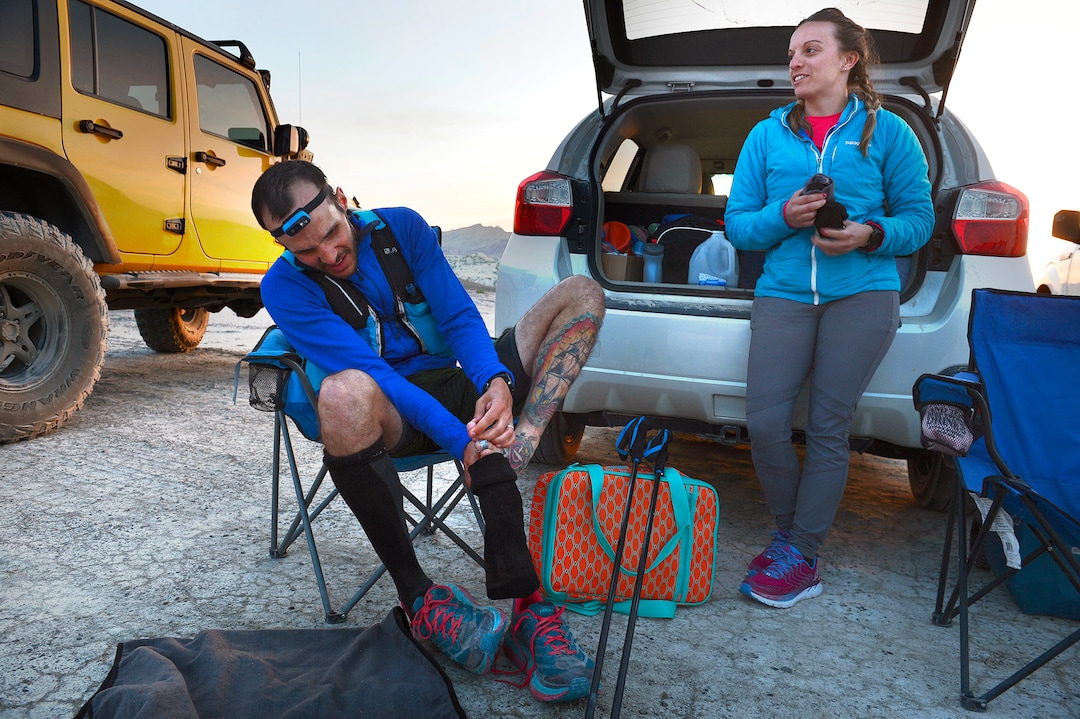 (Scott Sommerdorf | The Salt Lake Tribune)Alex Doolan changes his socks and tends to his feet at the last checkpoint at the Salt Flats 100 Endurance Run, Saturday, May 5, 2018.