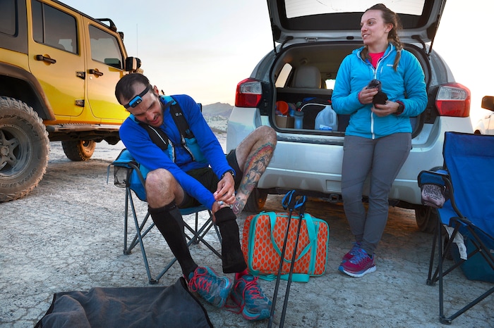 (Scott Sommerdorf | The Salt Lake Tribune)
Alex Doolan changes his socks and tends to his feet at the last checkpoint at the Salt Flats 100 Endurance Run, Saturday, May 5, 2018.
