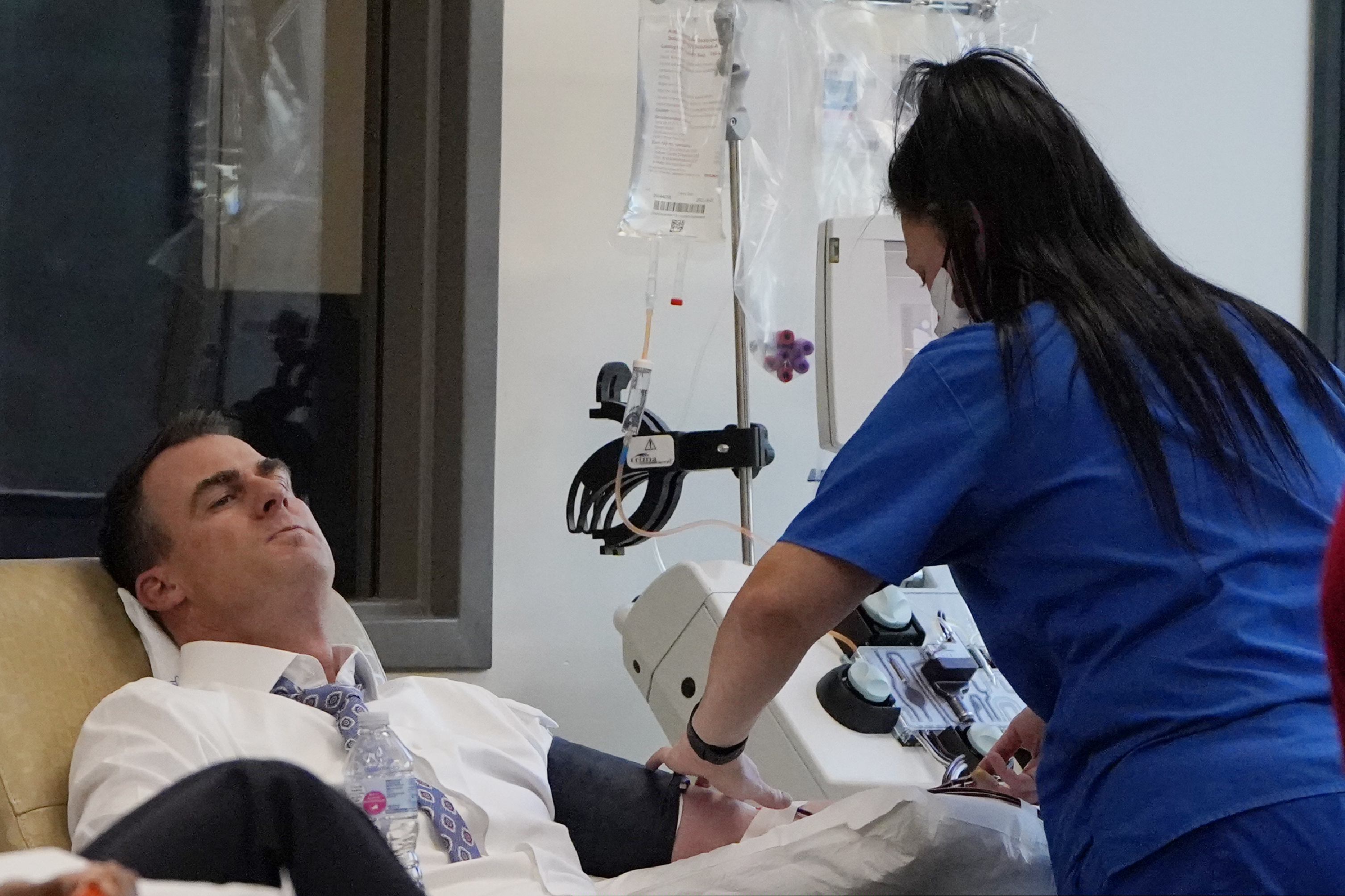 (Sue Ogrocki | AP photo)
Oklahoma Gov. Kevin Stitt, left, donates convalescent plasma at the Oklahoma Blood Institute in Oklahoma City, Tuesday, Dec. 1, 2020. This is Gov. Stitt's second time donating plasma since he tested positive for the coronavirus in July.