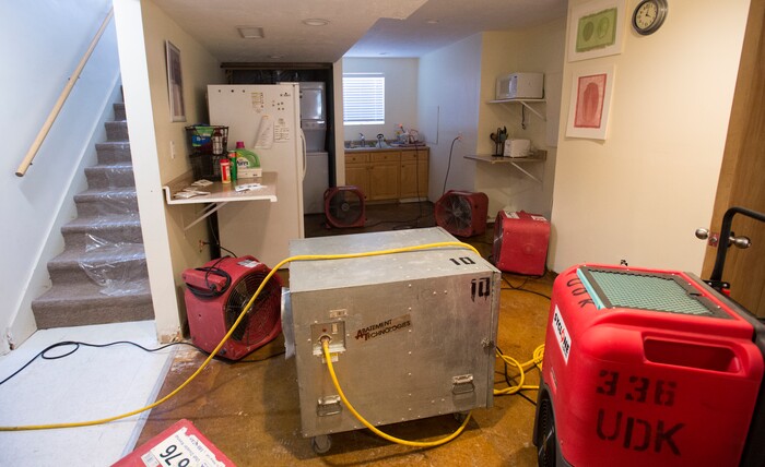 (Rick Egan  |  The Salt Lake Tribune)  Fans dry the basement of the Gisseman home, after the carpet and furniture were removed from the home on 2100 South. Tuesday, August 1, 2017.