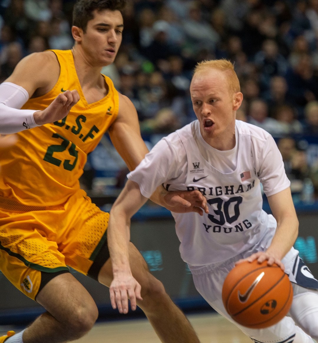 (Rick Egan  |  The Salt Lake Tribune)      Brigham Young Cougars guard TJ Haws (30) takes the ball up the middle, as San Francisco Dons guard Jordan Ratinho (25), in WCC basketball action at the Marriott Center, Thursday, February 21, 2018.