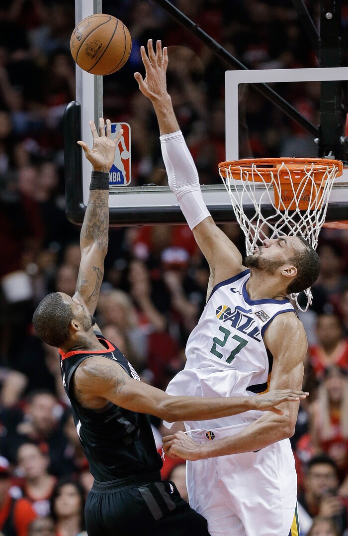 Houston Rockets forward Trevor Ariza, left, shoots as Utah Jazz center Rudy Gobert defends during the second half in Game 5 of an NBA basketball second-round playoff series, Tuesday, May 8, 2018, in Houston. (AP Photo/Eric Christian Smith)