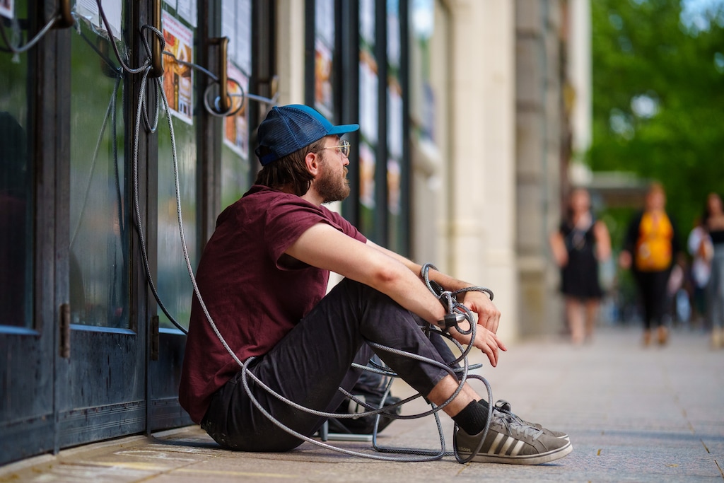 (Trent Nelson  |  The Salt Lake Tribune) Michael Valentine, chained to the Utah Theater in Salt Lake City on Tuesday, June 8, 2021, has now unhooked himself from the building and ended his hunger strike. But he is continuing his protest to try to save the playhouse from demolition.