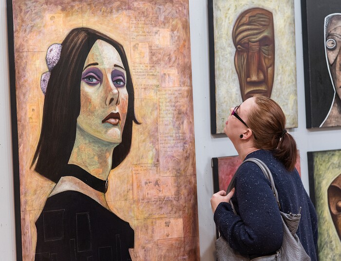 (Michael Mangum  |  Special to the Tribune) Kami Koyle, a 2-year patron of at the art exhibition called Connect, analyzes a painting in a separate gallery at the Urban Arts Gallery in Salt Lake City, UT on Friday, November 8th, 2019.
