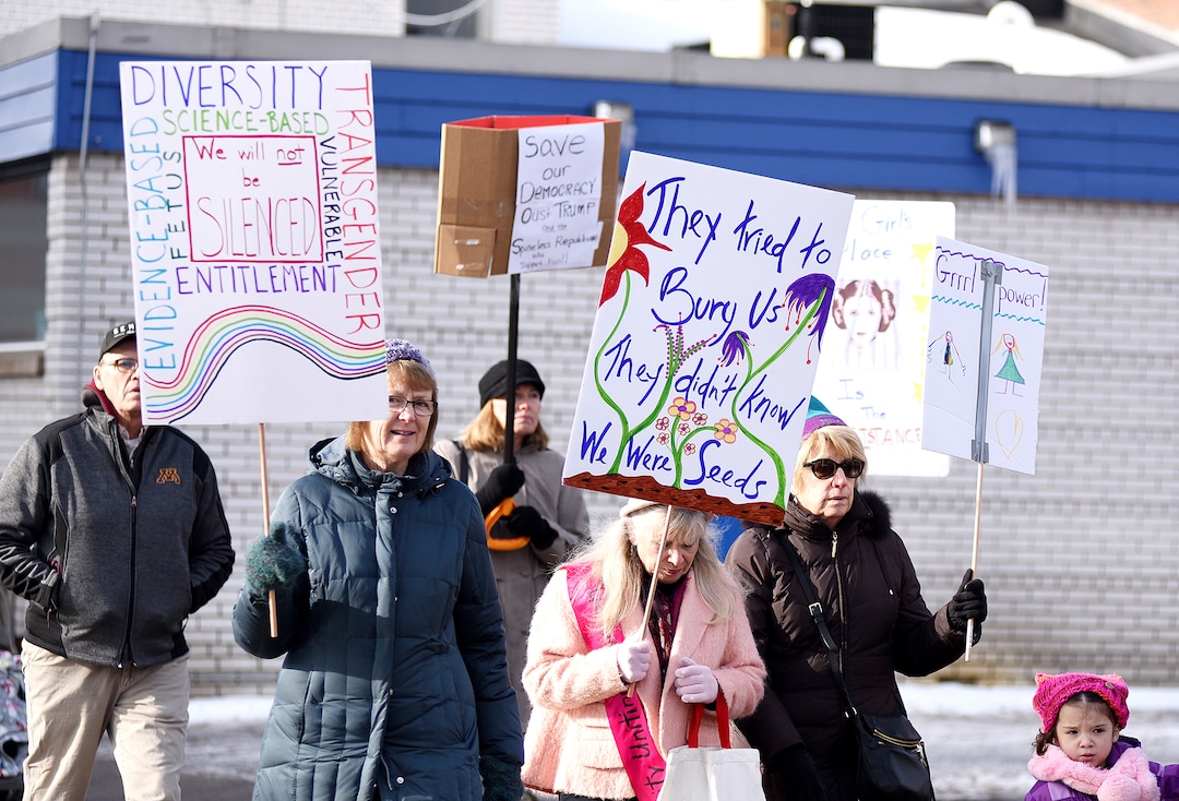 Hundreds march Saturday, Jan. 20, 2018 through downtown Eau Claire, Wis. as part of the Women's March Wisconsin Day of Action. The march followed a rally at Phoenix Park and was a companion event to marches in Milwaukee and Green Bay. (Elena Dawson/The Eau Claire Leader-Telegram via AP)