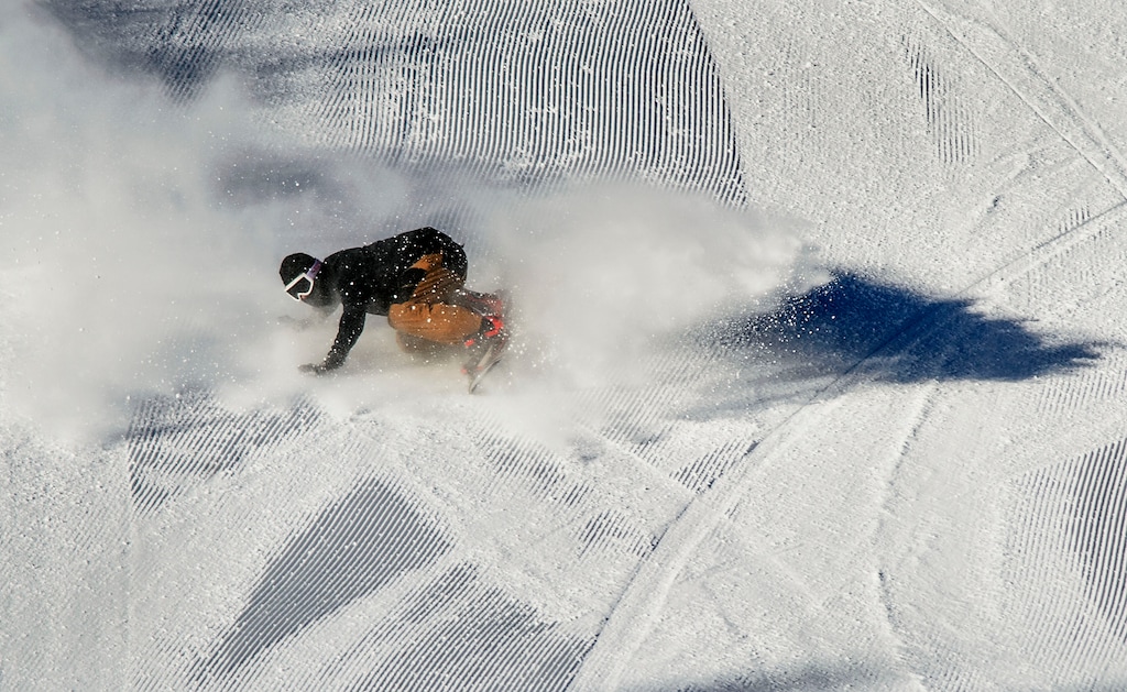 (Steve Griffin  |  The Salt Lake Tribune) A snowboarder carves a turn on a groomed run at Brighton ski area in Salt Lake City, Monday, Jan. 1, 2018.