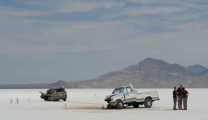 (Francisco Kjolseth | The Salt Lake Tribune) Highway patrol investigate the scene of a deadly crash at Utah's Bonneville Salt Flats along the sidelines of Speed Week following a head-on collision between two vehicles carrying support crew traveling between the pits and the entrance to the salt along the access road on Wednesday, Aug. 16, 2017. One person was killed and five injured, all of whom were said to be members of support crews for racing drivers.