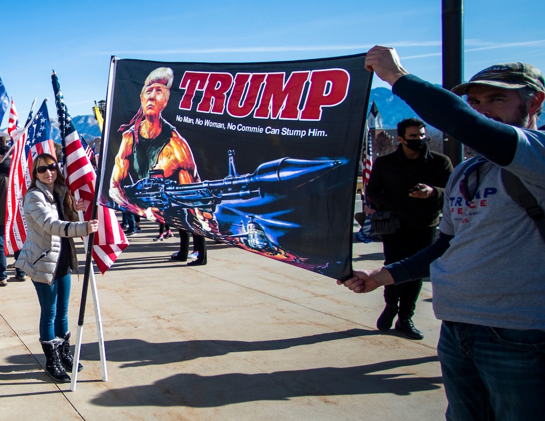 (Rick Egan | The Salt Lake Tribune). A small crowd of Trump protesters gather at the capitol with signs, flags and guns on Wednesday, Jan. 6, 2021.