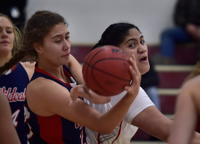 (Scott Sommerdorf   |  The Salt Lake Tribune)   East's Lani Taliauli, right, and Riley Aiono battle in the paint during first half play. East beat Woods Cross 50-36, Friday, December 15, 2017.  