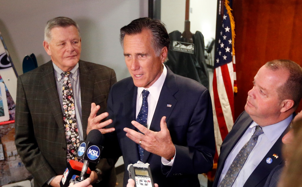 U.S. Sen. Mitt Romney, center, R-Utah, speaks with reporters after visiting with local officials to discuss how the four-week partial government shutdown is impacting an area with several major federal employers, including the Internal Revenue Service, Friday Jan., 18, 2019, in Ogden, Utah. (AP Photo/Rick Bowmer)