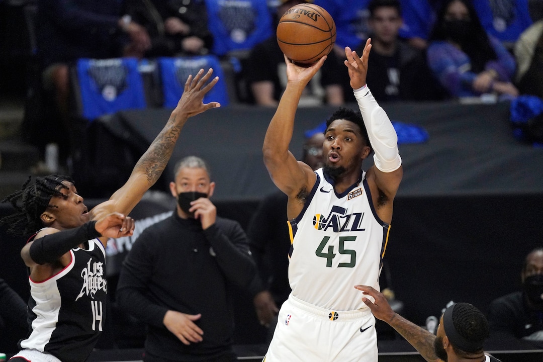 Utah Jazz guard Donovan Mitchell, right, shoots as Los Angeles Clippers guard Terance Mann defends during the first half in Game 6 of a second-round NBA basketball playoff series Friday, June 18, 2021, in Los Angeles. (AP Photo/Mark J. Terrill)