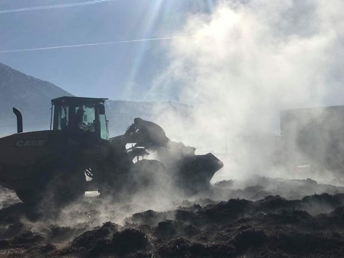 (Photo courtesy of the Juab County Fire District) Juab County Fire District crews responded to a report of a fire at the Young Living Lavender Farm in Mona on Sunday morning. A compost pile of Pinyon juniper spontaneously combusted. While the fire is relatively small, the large compose pile continues to smolder after crews have been working on it for more than a day.