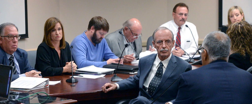 (Al Hartmann  |  Tribune file photo)
Salt Lake County County Recorder Gary Ott, right, turns to listen to District Attorney Sim Gill speak on findings of the County Auditor's performance audit of his office Tuesday Oct. 4.  Salt Lake County Council, behind.
