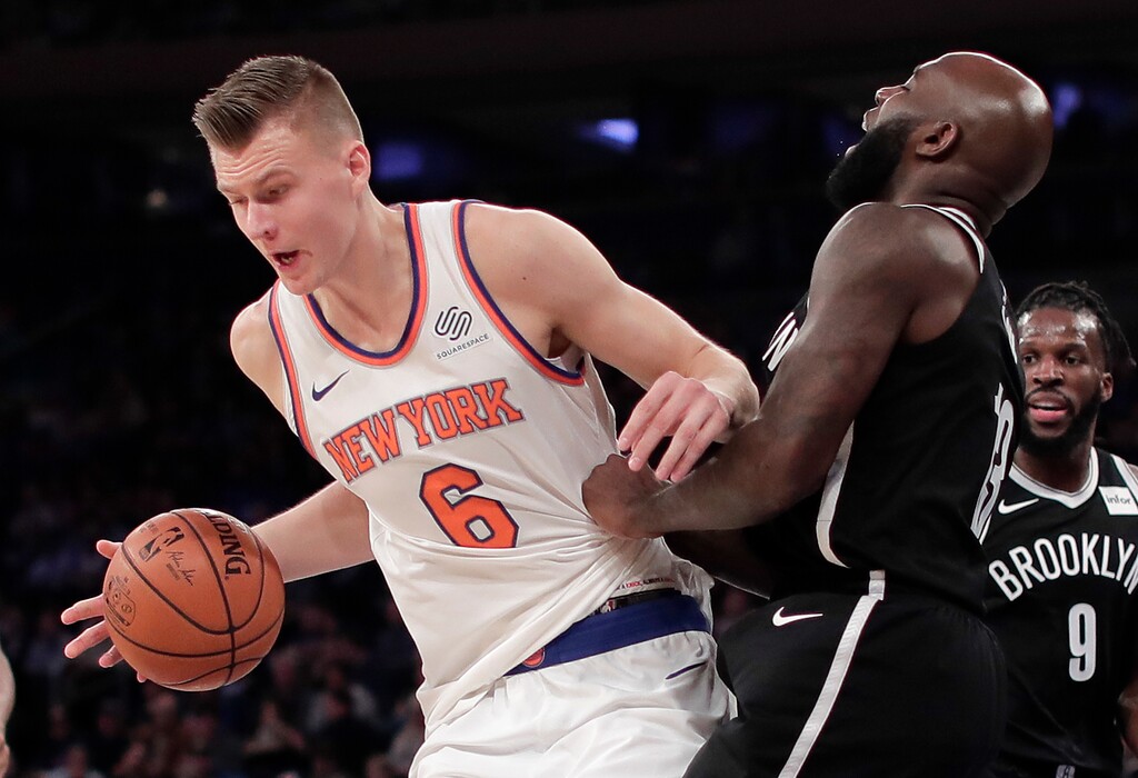 New York Knicks forward Kristaps Porzingis (6) drives the lane against Brooklyn Nets forward Quincy Acy (13) during the second quarter of an NBA basketball game, Friday, Oct. 27, 2017, in New York. (AP Photo/Julie Jacobson)
