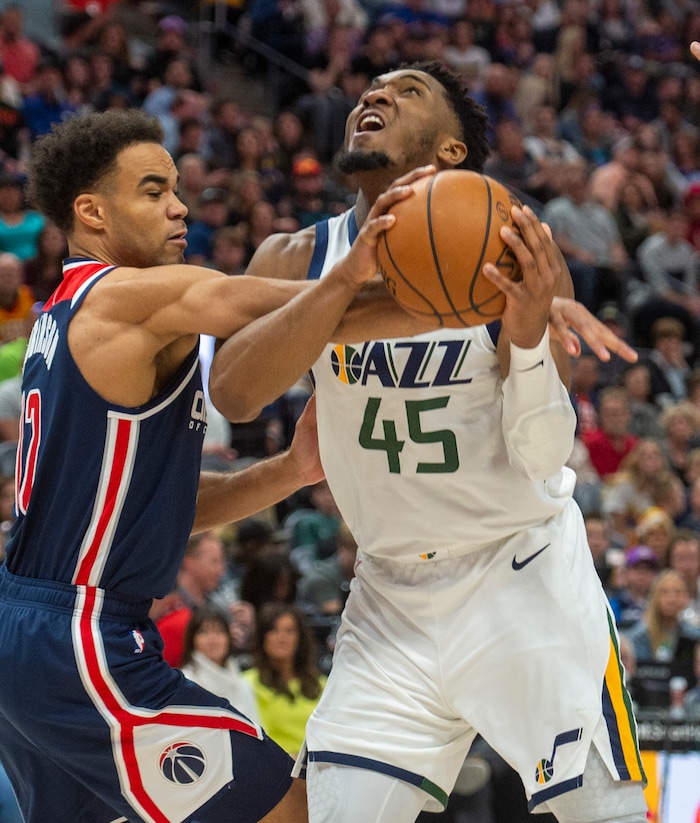 (Rick Egan  |  The Salt Lake Tribune)    Washington Wizards guard Jerome Robinson (12) gets a piece of Utah Jazz guard Donovan Mitchell's arm, in NBA action between the Utah Jazz and the Washington Wizards, in Salt Lake City, Friday, February 28, 2020