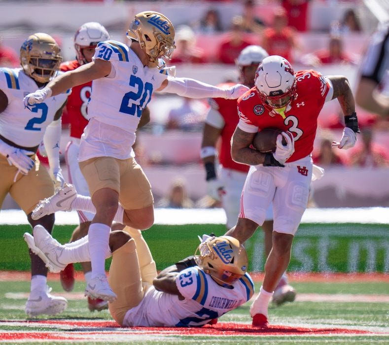 (Rick Egan | The Salt Lake Tribune)  Utah Utes running back Ja'Quinden Jackson (3) tries to get out of the arms of UCLA Bruins defensive back Kenny Churchwell III (23), in PAC-12 football action between the Utah Utes and the UCLA Bruins, at Rice-Eccles Stadium, on Saturday, Sept. 23, 2023.