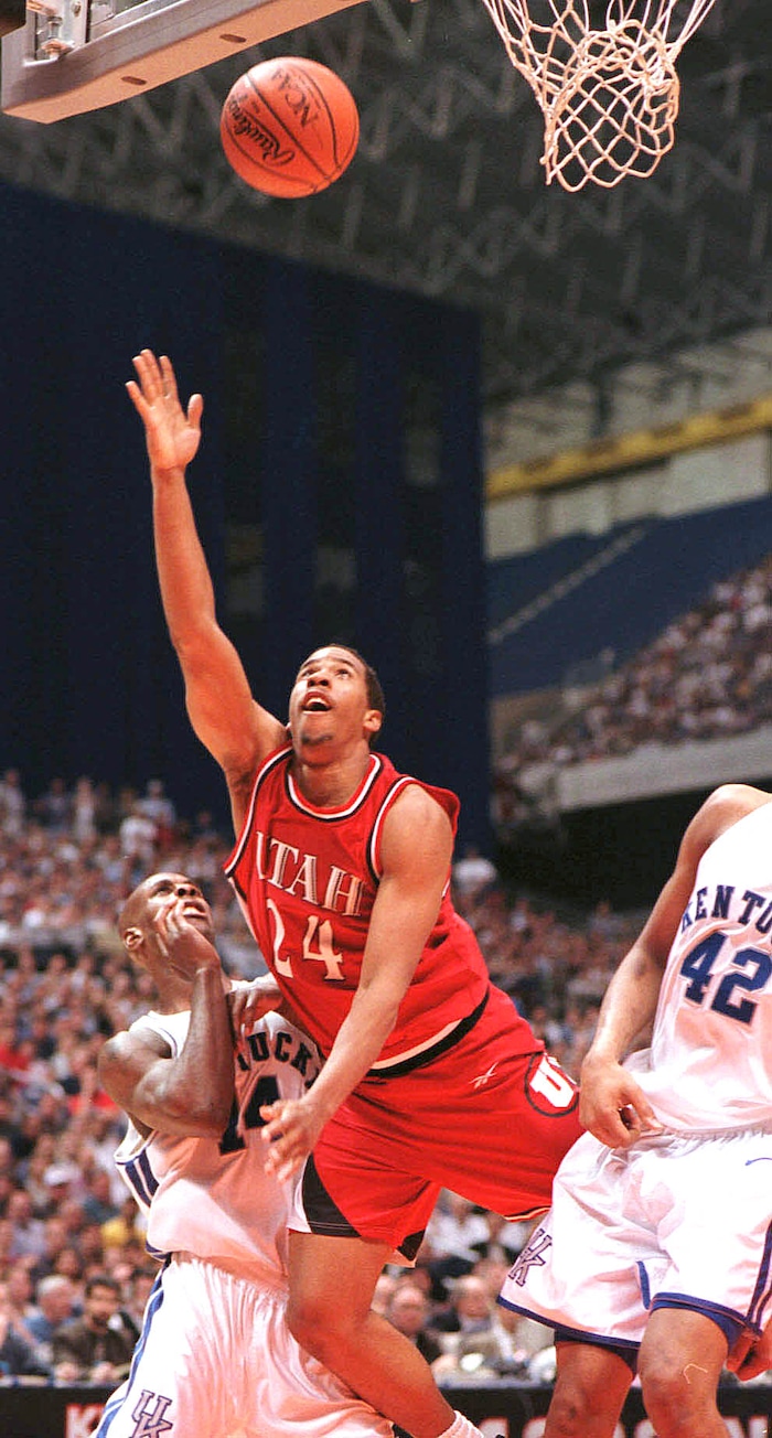 (Steve Griffin  |  Tribune file photo)  Utah's Andre Miller scores as he falls to the ground over Kentucky's Heshimu Evans and Jamaal Magliore (42) in the 1998 national championship game at the Alamodome in San Antonio, Texas. 