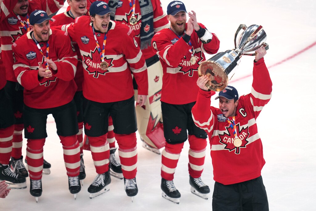 (Charles Krupa | AP) Canada captain Sidney Crosby, right, hoists the trophy after defeating the United States following an overtime period of the 4 Nations Face-Off championship hockey game, Thursday, Feb. 20, 2025, in Boston.
