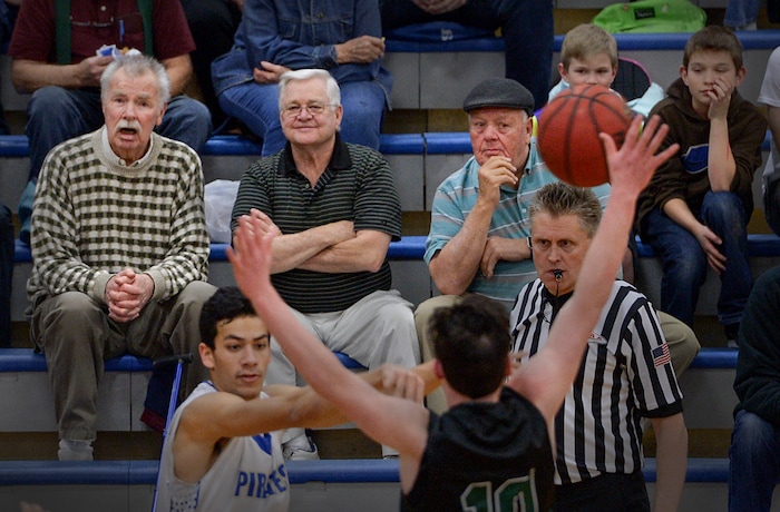 (Leah Hogsten | The Salt Lake Tribune) l-r Cyprus High School former students, coaches and boosters, Glen Rupp, Dennis Dea and Sonny Sudbury take in a basketball game. Cyprus High School has grown and changed since the gym and what may be the state's oldest operating indoor pool were constructed in 1955. A new school is in the works, badly needed to accommodate a growing population on the west side's close-knit community, where long-time fans show up no matter how good or bad the Pirates are.