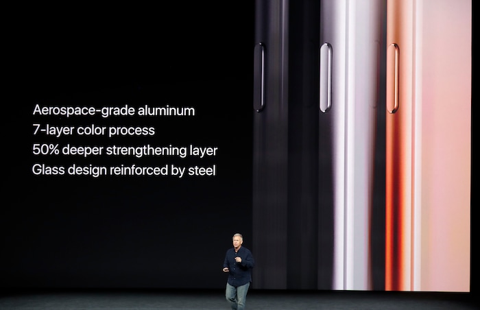 Phil Schiller, Apple's senior vice president of worldwide marketing, shows the new iPhone 8 at the Steve Jobs Theater on the new Apple campus on Tuesday, Sept. 12, 2017, in Cupertino, Calif. (AP Photo/Marcio Jose Sanchez)