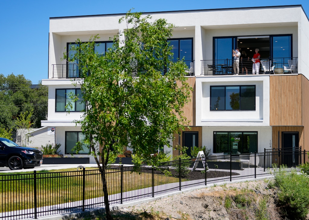 (Bethany Baker  |  The Salt Lake Tribune) Prospective buyers walk through the model home at Opus Green, a new town home project in Millcreek that offers eco-friendly homes alongside a stretch of Big Cottonwood Creek, on Wednesday, June 5, 2024.