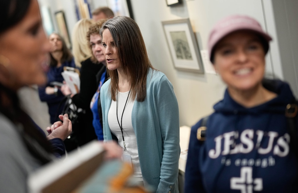 (Francisco Kjolseth | The Salt Lake Tribune) Utah State Board of Education member Natalie Cline is surrounded by supporters in the hallway during the first regular USBE meeting since her censure, on Thursday, March 7, 2024.