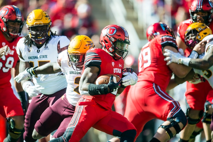 (Chris Detrick  |  The Salt Lake Tribune)  Utah Utes running back Zack Moss (2) runs past Arizona State Sun Devils linebacker Christian Sam (2) during the game at Rice-Eccles Stadium Saturday, October 21, 2017. 