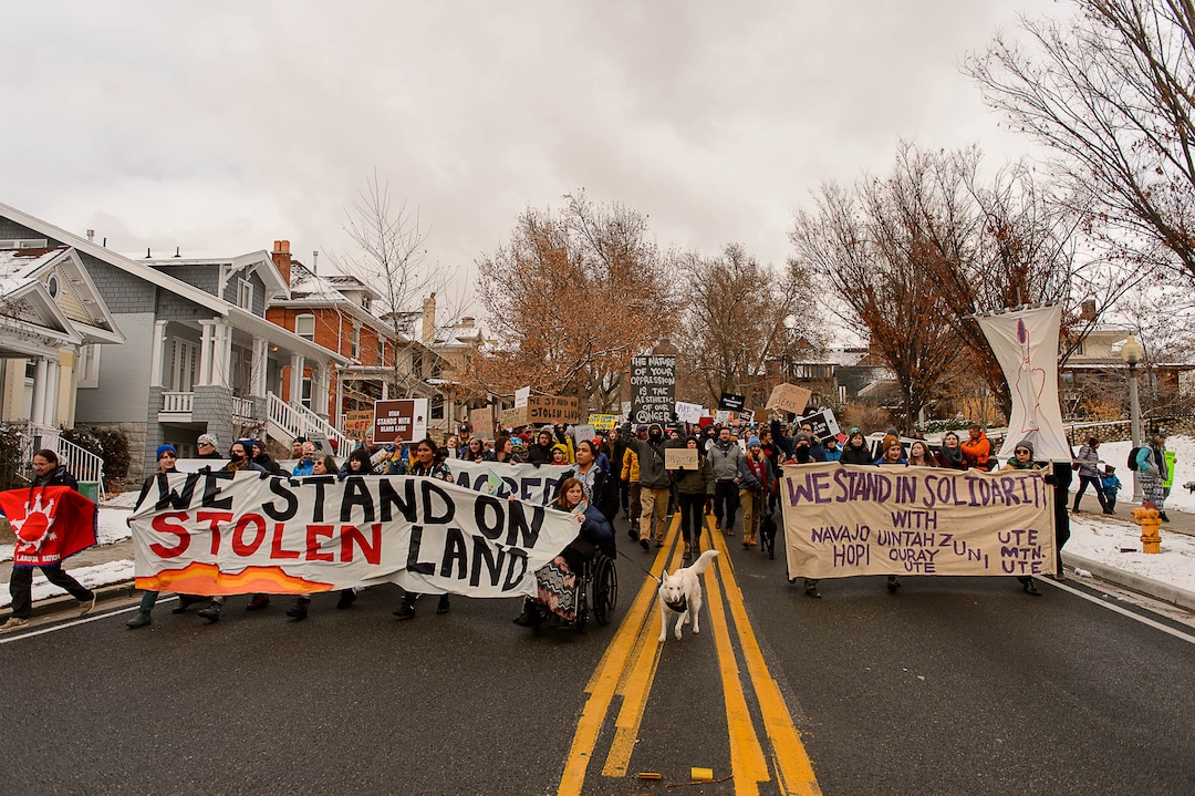 (Trent Nelson | The Salt Lake Tribune)  Protesters march down State Street during rally against a visit by President Donald Trump, Monday December 4, 2017.
