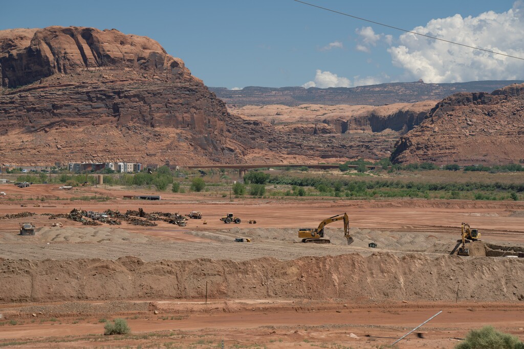 (Trevor Christensen | The Salt Lake Tribune) Construction equipment gathers radioactive mill tailings at the Utah Moab Uranium Mill Tailings Remedial Action (UMTRA) Project on Wednesday, Aug. 14, 2024.
The 480-acre site was once the home of a uranium mill that processed 1,400 tons of uranium ore per day.
