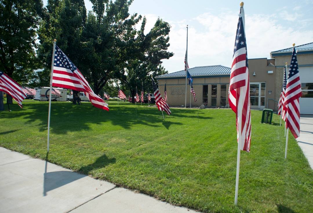 (Rick Egan  |  The Salt Lake Tribune)      American flags fly at the Draper Fire Station in memory of Draper firefighter Matt Burchett, 42, who died fighting wildfires in California. Tuesday, Aug. 14, 2018.