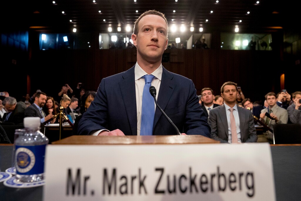 FILE - In this April 10, 2018 file photo, Facebook CEO Mark Zuckerberg arrives to testify before a joint hearing of the Commerce and Judiciary Committees on Capitol Hill in Washington about the use of Facebook data to target American voters in the 2016 election. Some political die-hards are getting caught up in an expanded effort by Facebook and other social media companies to crack down on nefarious tactics suspected of interfering in the 2016 election. They have been flagged as "bots," or robot-like automated accounts, because they tweet prolifically. (AP Photo/Andrew Harnik File)
