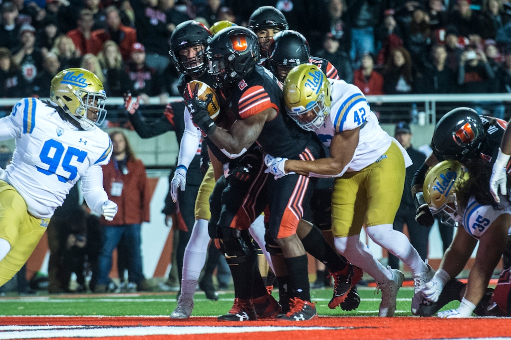 (Chris Detrick  |  The Salt Lake Tribune)  Utah Utes running back Zack Moss (2) scores a touchdown past UCLA Bruins linebacker Kenny Young (42) during the game at Rice-Eccles Stadium Friday, November 3, 2017.   