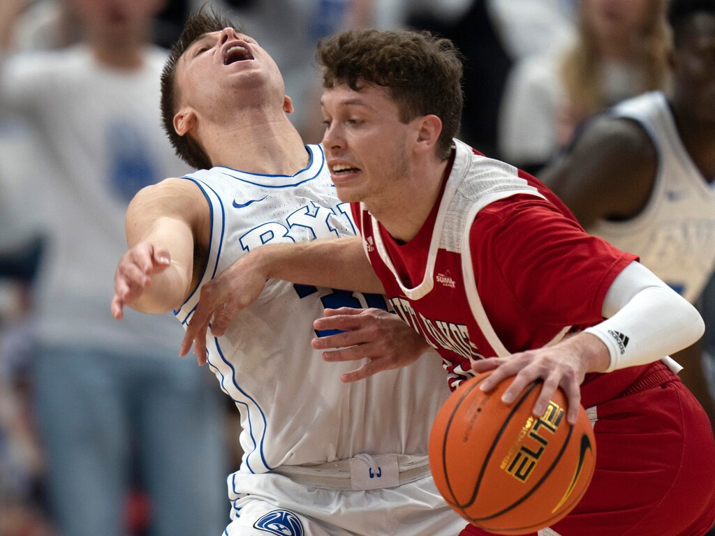 (Rick Egan | The Salt Lake Tribune)  South Dakota Coyotes guard A.J. Plitzuweit (10) collides with Brigham Young Cougars guard Dallin Hall (30), in basketball action between the Brigham Young Cougars and the South Dakota Coyotes, at Vivint Arena, in Salt Lake City, on Saturday, Dec. 3, 2022.