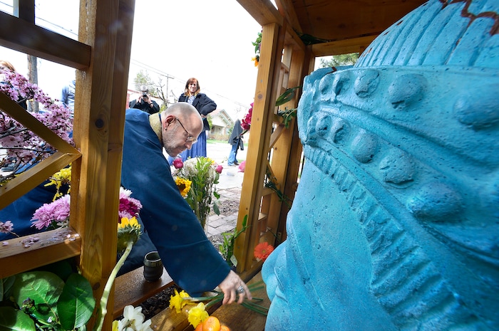 (Scott Sommerdorf | The Salt Lake Tribune)
The Salt Lake Buddhist Fellowship Sensei, Christopher Kakuyo Ross-Leibow, places offerings prior to the rededication ceremony for the Buddha on 9th, the Sugar House landmark and Buddhist Shrine, Sunday, April 8, 2018.