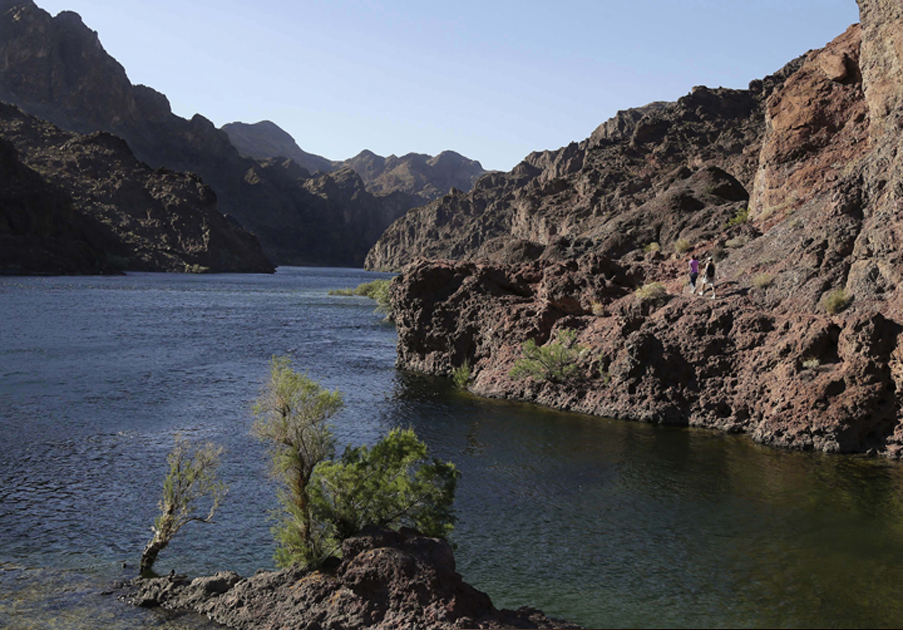 (Julie Jacobson | The Associated Press) In this April 14, 2013 file photo, hikers make their way along the banks of the Colorado River near Willow Beach, Ariz. Work on a multistate plan to address drought on the Colorado River in the U.S. West won't be done to meet a Monday, March 4, 2019 federal deadline. A California irrigation district with the highest-priority rights to the river water says it won't approve the plan without securing money to restore the state's largest lake. The Imperial Irrigation District wants $200 million for the Salton Sea, a massive, briny lake in the desert southeast of Los Angeles.