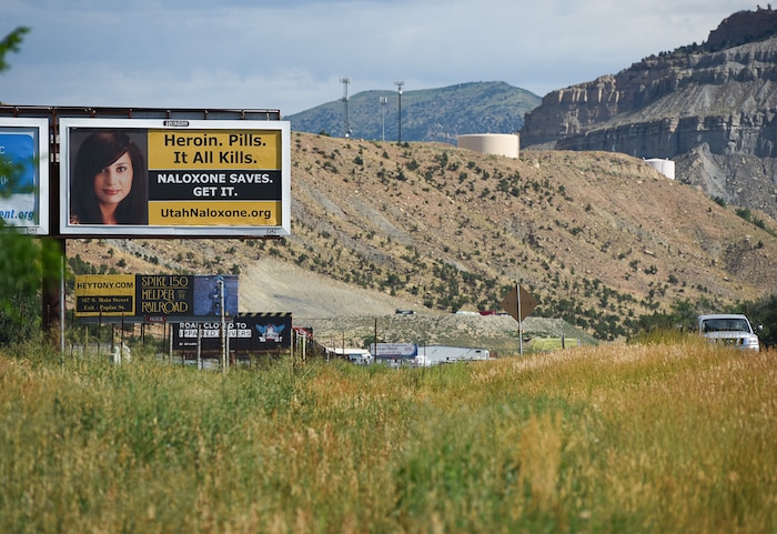(Francisco Kjolseth | The Salt Lake Tribune)  Traffic rolls past a billboard bringing attention to the opioid crisis along U.S. Route 191 in Carbon County where at least 93 people have died to opioid overdose between 2000 and 2018, according to data from the Utah Department of Health.