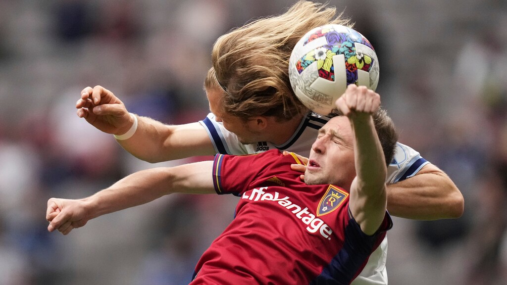 Real Salt Lake's Andrew Brody, front, and Vancouver Whitecaps' Florian Jungwirth vie for the ball during the first half of an MLS soccer match Saturday, June 4, 2022, in Vancouver, British Columbia. (Darryl Dyck/The Canadian Press via AP)