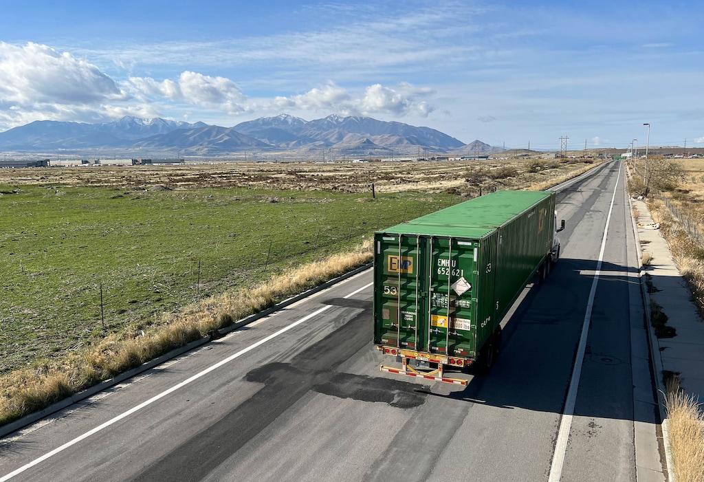 (Francisco Kjolseth | The Salt Lake Tribune) Trucks carrying shipping containers move in and out of the Union Pacific intermodal terminal at a steady pace, west of Salt Lake City. Directly south, at left, is the future site of the transloading facility, which will be the heart of the inland port, as seen on Wednesday, Nov. 10, 2021.