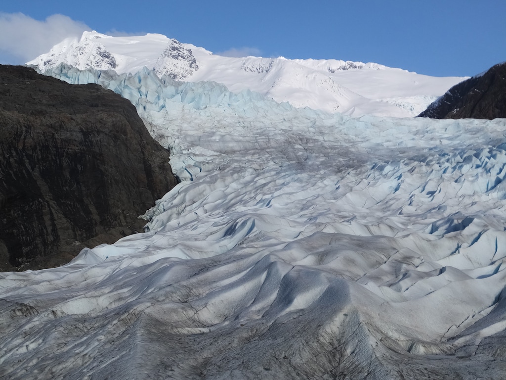 (Becky Bohrer | The Associated Press) In this Feb. 15, 2016 file photo, snow-covered mountains are seen behind the Mendenhall Glacier in Juneau, Alaska. The massive Alaska ice field that feeds Juneau's Mendenhall Glacier, a tourist attraction viewed by hundreds of thousands each year, could be gone by 2200 if climate warming trends continue, according to a new University of Alaska Fairbanks study.