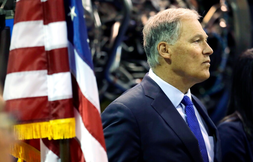 In this June 6, 2018 photo, Washington Gov. Jay Inslee waits to speak at South Seattle College in Seattle during a news conference. Inslee, a two-term Democratic governor and former congressman, is likely best known outside the state for his focus on climate issues and renewable energy, but lately he's getting notice for a different role: an adversary to President Donald Trump. And while he's aware of the 2020 presidential chatter that includes his name, Inslee steers conversations on that topic to other elections. (AP Photo/Ted S. Warren)