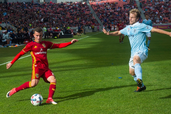 (Chris Detrick  |  The Salt Lake Tribune)  Real Salt Lake forward Brooks Lennon (27) kicks around Sporting Kansas City defender Seth Sinovic (15) during the game at Rio Tinto Stadium Sunday, October 22, 2017.  