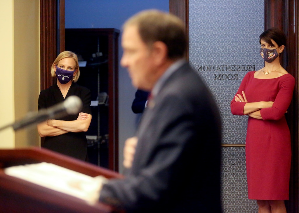 (Kristin Murphy | Deseret News, pool) Dr. Emily Spivak, University of Utah Health Division of Infectious Diseases associate professor of medicine, and Dr. Angela Dunn, state epidemiologist, listen as Gov. Gary Herbert speaks during a COVID-19 press conference at the Capitol in Salt Lake City on Thursday, Oct. 8, 2020.