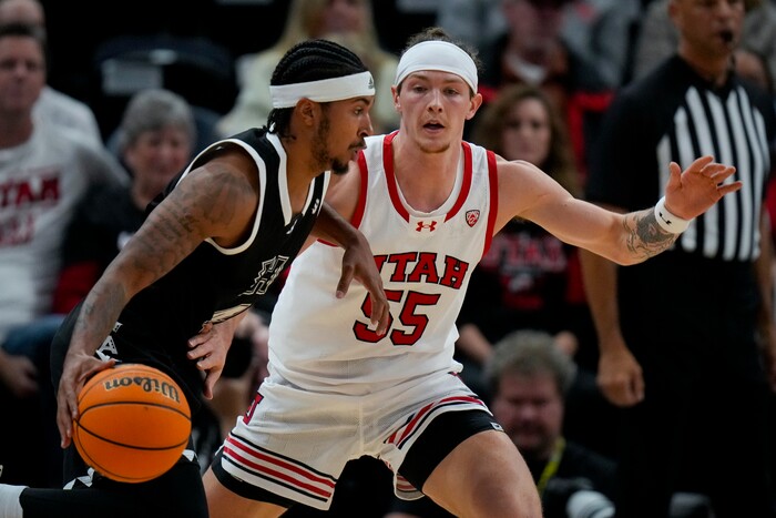 (Bethany Baker  |  The Salt Lake Tribune) Hawaii Warriors guard Noel Coleman (4) moves the ball as Utah Utes guard Gabe Madsen (55) defends at the Delta Center in Salt Lake City on Thursday, Nov. 30, 2023.