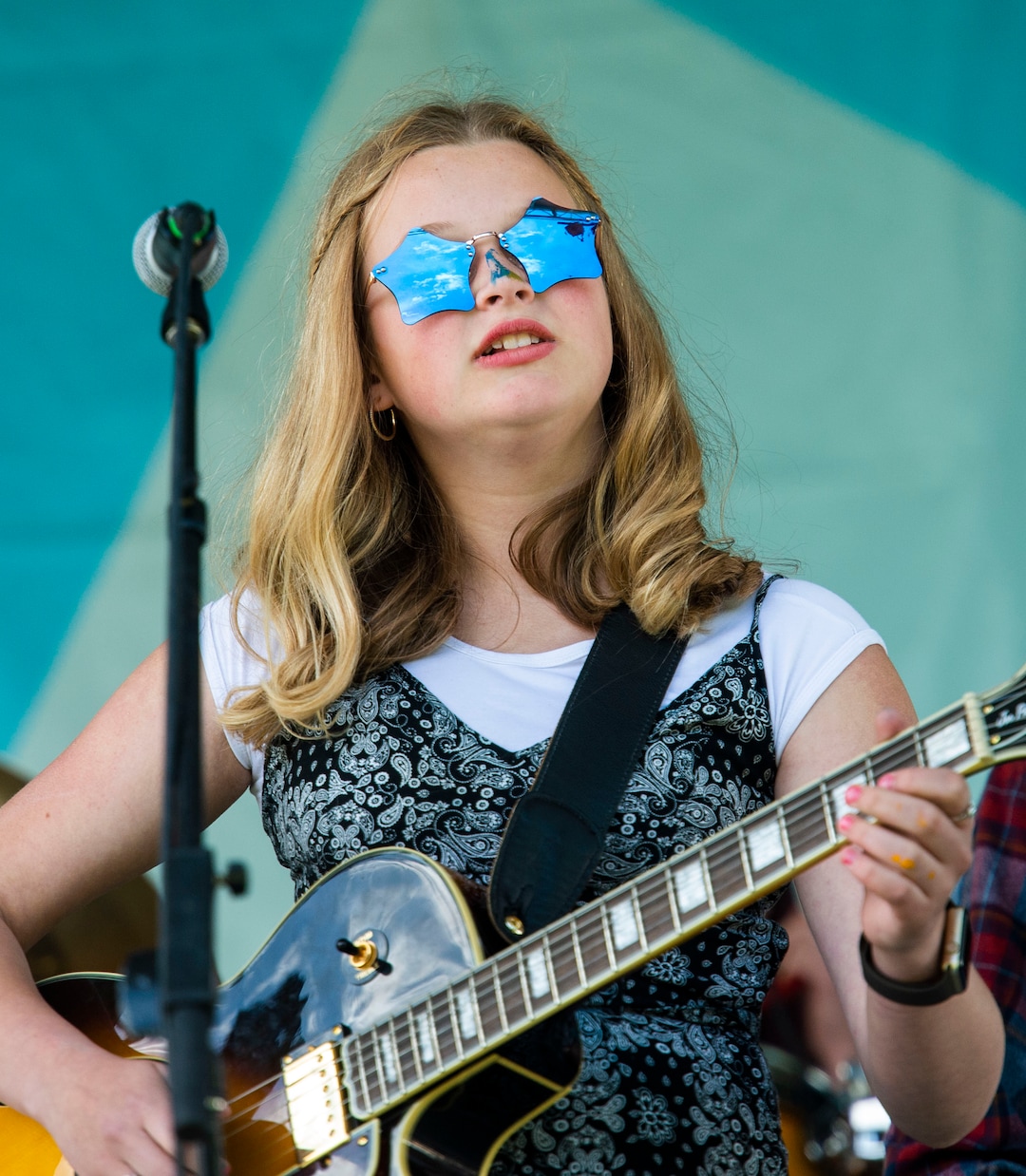 (Rick Egan  |  The Salt Lake Tribune)   Gwen McConkie, 15, sings for the band Sincerely, The Universe, at the Utah Arts Festival, Saturday, June 22, 2019.